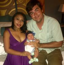 Early image of young Daniel and Mari, his wife, holding their first baby